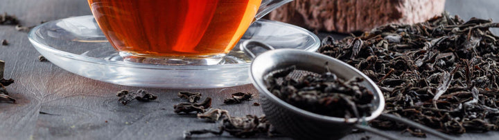 Tea cup with tea leaves on a stone surface