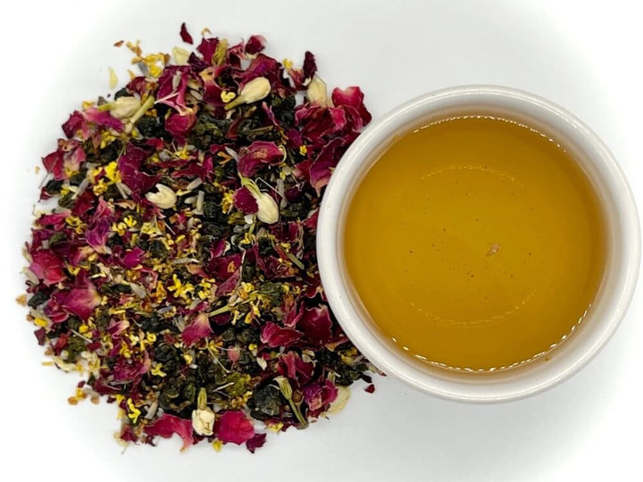Tea leaves and a cup of tea on a white background